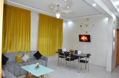 a living room with a couch and a table at Riad Bollywood- family charm in Benguerir