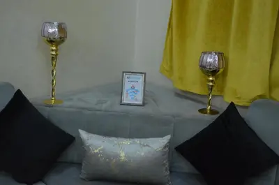 a living room with two wine glasses and a couch at Riad Bollywood- family charm in Benguerir