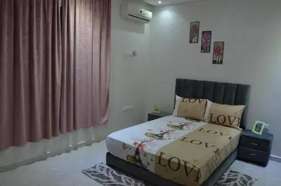a bedroom with a bed with the words loveoko on it at Riad Bollywood- family charm in Benguerir