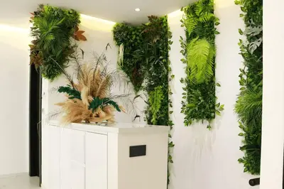 a room with a wall covered in green plants at Duplex piscine chauffée terrasse in Marrakech
