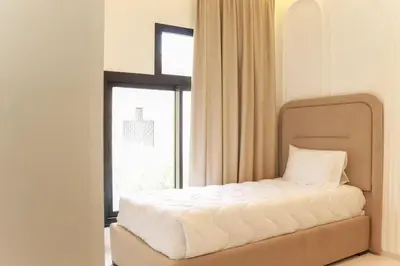 a bedroom with a bed in front of a window at Duplex piscine chauffée terrasse in Marrakech