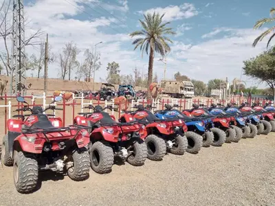 a row of red and blue atvs parked next to a fence at Quad Marrakech in Marrakech