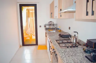 a kitchen with a stove and a counter top at appartement hivernage marrakech avec piscine in Marrakech