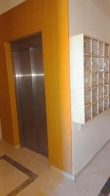 a locker room with a metal door in a building at appartement hivernage marrakech avec piscine in Marrakech