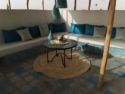 a living room with a couch and a table at Riad EL BADI in Marrakech