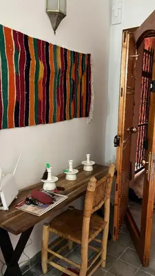 a room with a wooden table with a telephone at Riad EL BADI in Marrakech