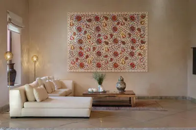 a living room with a couch and a painting on the wall at Villa JENAMAN in Marrakech