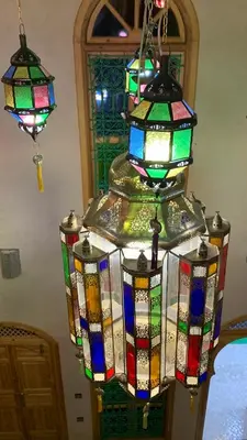 a group of colorful stained glass chandeliers hanging at Riad SunSet Marrakech in Marrakech