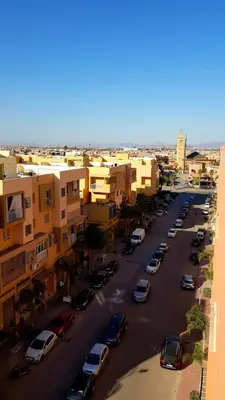 a city street with cars parked in a parking lot at Beautiful Apartment Near Airport in Marrakech