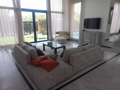 a living room with a couch and a tv at H Amelkis in Marrakech