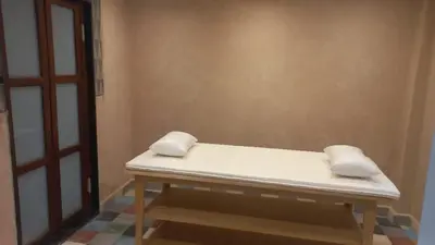 a white bed sitting in a room next to a door at H Amelkis in Marrakech