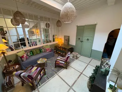 a living room with a couch and chairs and a mirror at DarDabakech, proche Jemma el Fna, souk, riad, centre Medina - Maison entière de 2 à 6 personnes, possibilité 3 chambres in Marrakech