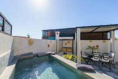 a swimming pool on a patio with a table and chairs at Riad Taher Bed & Breakfast - Top position Médina in Marrakech