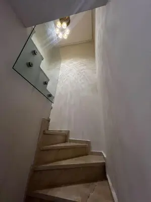 a staircase in a building with a mirror on it at Nouvel appartement de luxe Pearl garden in Marrakech