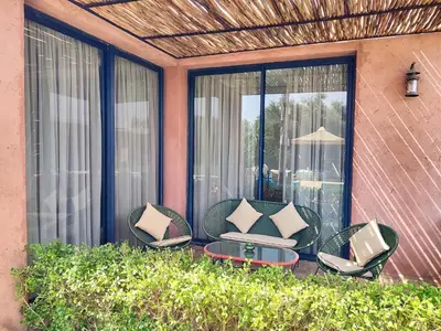 a group of chairs on a patio with a table at Domaine Homa Marrakech in Marrakech
