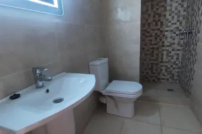 a bathroom with a white toilet and a sink at Luxury city center apartment with swimming pool in Marrakech