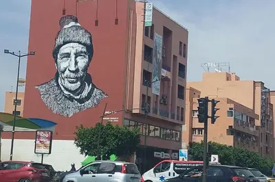 a large painting of a man on the side of a building at Luxury city center apartment with swimming pool in Marrakech