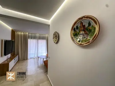 a plate hanging on the wall of a living room at Premium Hivernage Amazigh 2BR Flat - Zayane Homes in Marrakech