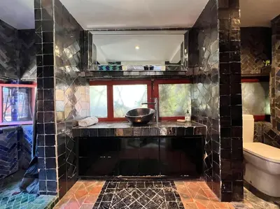 a bathroom with a counter with a sink and a toilet at Designer Villa in La Palmeraie Marrakech in Marrakech