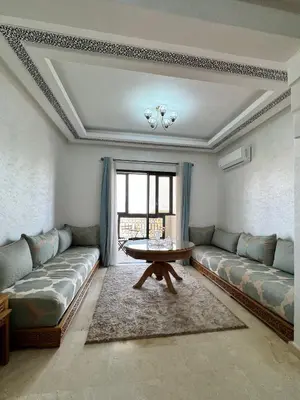 a living room with two couches and a table at À 6 min du stade - Résidence avec Piscine, Wifi, Gardien H24 in Marrakech