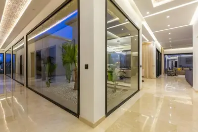 a hallway with glass windows in a building at Villa luxueuse sans vis à vis - Piscine chauffée in Marrakech