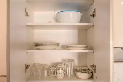 a cupboard filled with plates and bowls and dishes at Oasis urbaine - Pearl Garden luxe et confort in Marrakech