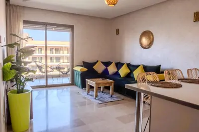 a living room with a couch and a table at Oasis urbaine - Pearl Garden luxe et confort in Marrakech