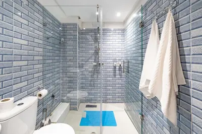 a bathroom with blue tiled walls and a shower at Cozy Studio with Mountain View in Gueliz, Marrakech in Marrakech