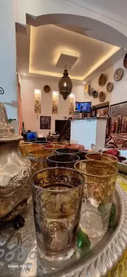 a group of glass vases sitting on a table at Hostel Dar Ben Youssef in Marrakech