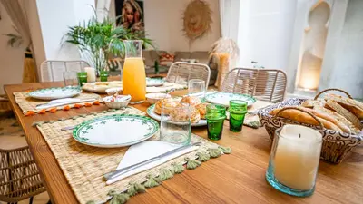 a table with plates of bread and glasses of orange juice at Riad Marssa, Privé Zen avec belle piscine dans la Médina in Marrakech
