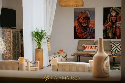 a living room with a couch and a table at Riad Marssa, Privé Zen avec belle piscine dans la Médina in Marrakech