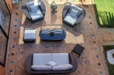 an overhead view of a patio with a couch and chairs at Villa beldi chic Amelkis golf in Marrakech