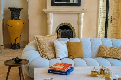 a living room with a blue couch with pillows at Villa beldi chic Amelkis golf in Marrakech