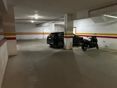 a parking garage with a car and a motorcycle in it at Appartement chic et cosy en plein centre de Gueliz in Marrakech