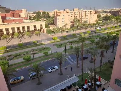 an aerial view of a street with palm trees and buildings at App spacieux marrakech centre ville in Marrakech