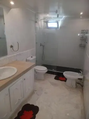 a bathroom with a sink and a toilet and a mirror at App spacieux marrakech centre ville in Marrakech