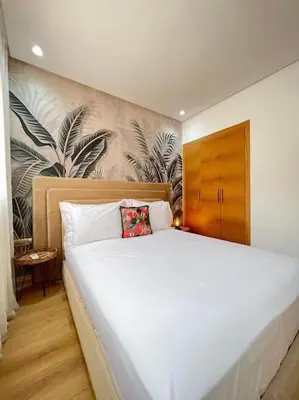a bedroom with a large white bed with at Appartement moderne au Golf in Marrakech