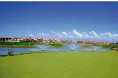 two water fountains in a park with a pond at Appartement moderne au Golf in Marrakech