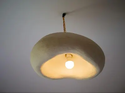 aendant light hanging from a ceiling in a room at Magnifique appartement 3 chambres à Prestigia in Marrakech