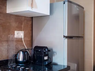 a kitchen with a counter with a toaster and a microwave at Magnifique appartement 3 chambres à Prestigia in Marrakech