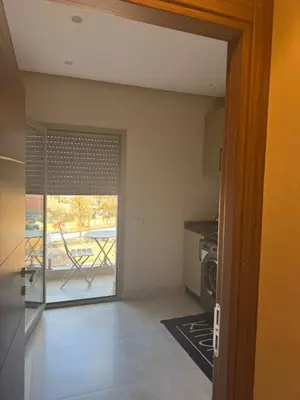 a living room with a door open to a kitchen at Superbe appart au centre de gueliz in Marrakech