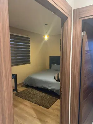 a bedroom with a bed and a door with a window at Superbe appart au centre de gueliz in Marrakech