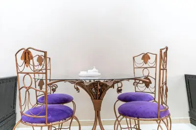 a dining room with purple chairs and a glass table at Peaceful Marrakech Villa 4 Bedrooms Private Pool in Marrakech