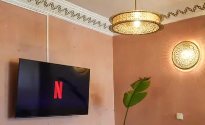 a television with the letter n on a wall at Stylish Moroccan Apartment Near Majorelle Garden, Wi-Fi, Free Airport Shuttle in Marrakech