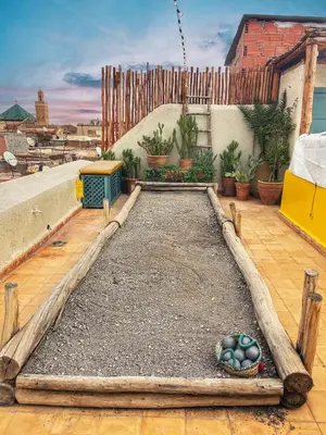 a garden with a bowl of eggs on a patio at Riad privé, 5 suites et piscine in Marrakech