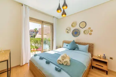 a bedroom with two towels on a bed at Luxurious Apartment Marrakech with Pool, Golf, Private Garden in Marrakech