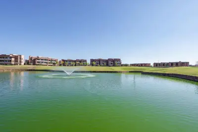 a large pond with a fountain in the middle of it at Luxurious Apartment Marrakech with Pool, Golf, Private Garden in Marrakech