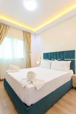 a bedroom with a large white bed with a bow on it at Step into Elegance - Marrakech in Marrakech