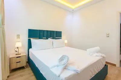 a bedroom with a large white bed with a blue headboard at Step into Elegance - Marrakech in Marrakech