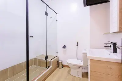 a bathroom with a shower and a toilet and a sink at Step into Elegance - Marrakech in Marrakech